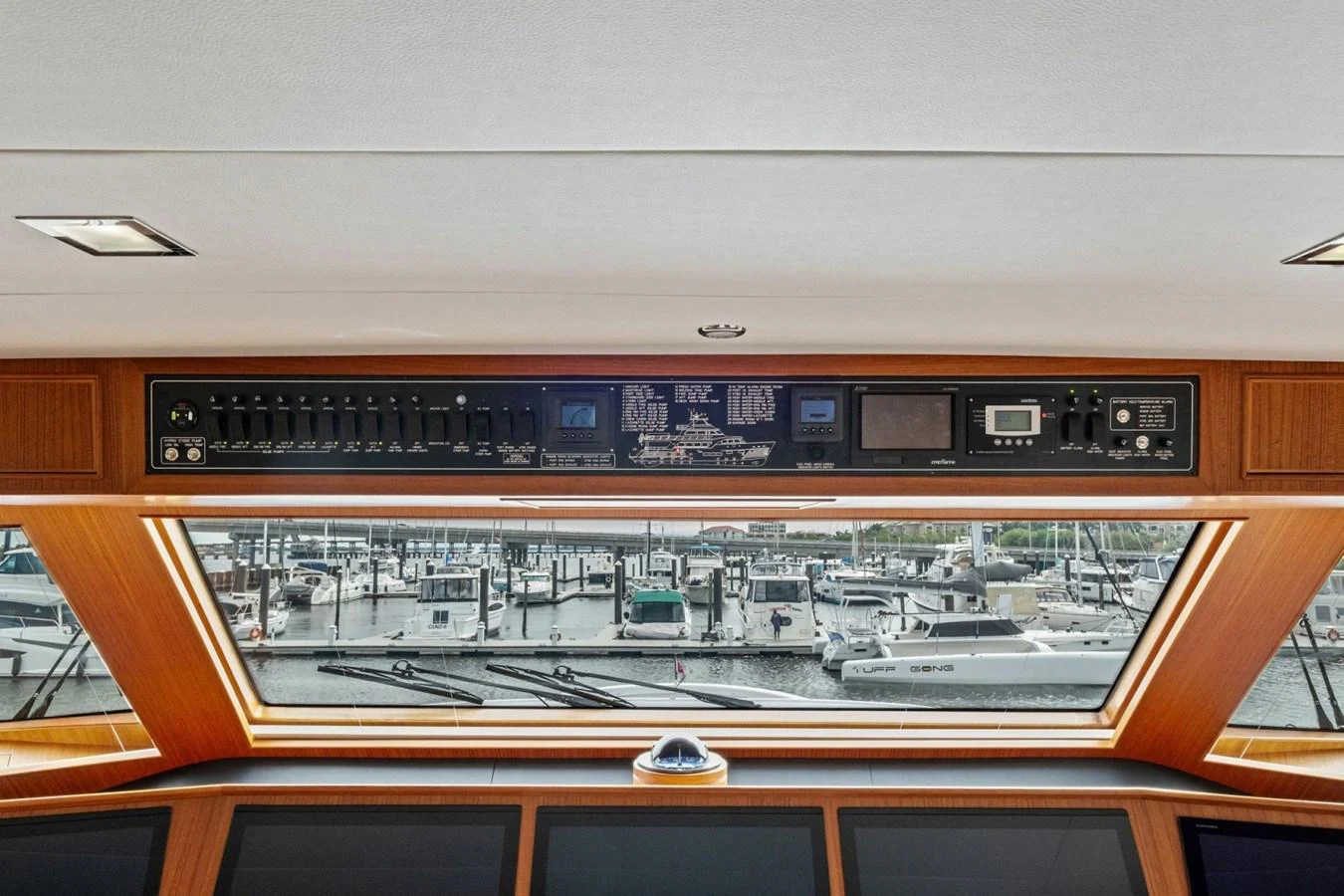 The helm station offers a commanding view of the marina through large windows, with advanced navigation and control panels overhead. aboard ARTEMIS II Yacht for Sale