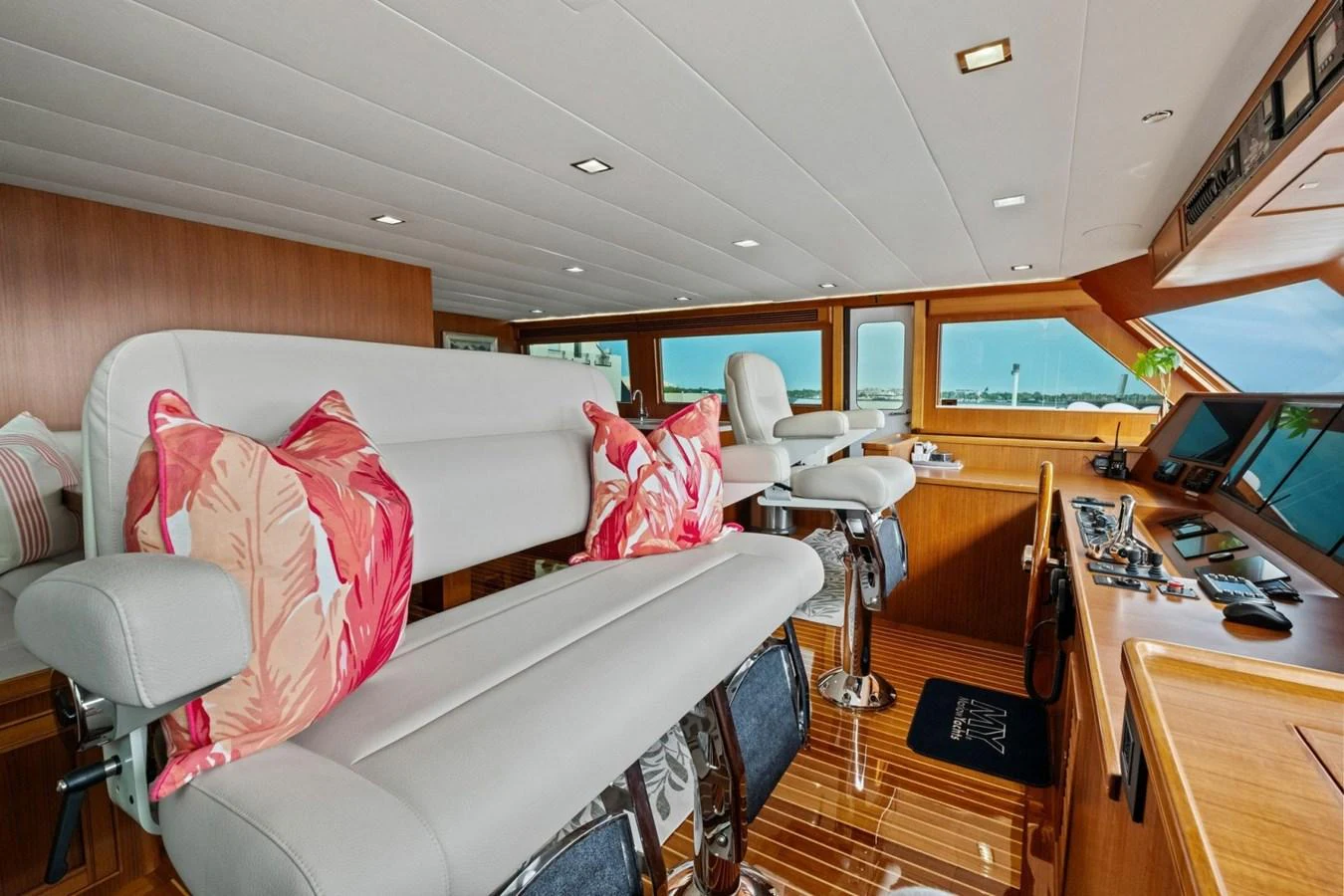 The helm area features plush seating and state-of-the-art navigation equipment, bathed in natural light. aboard ARTEMIS II Yacht for Sale