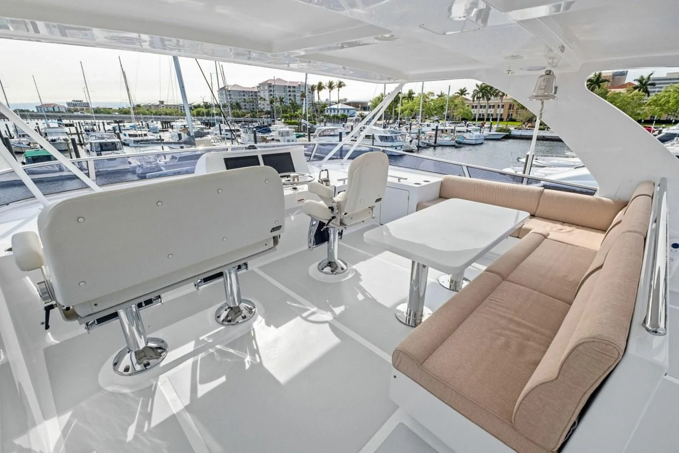 The flybridge offers a spacious and comfortable seating area with a view of the marina. aboard ARTEMIS II Yacht for Sale