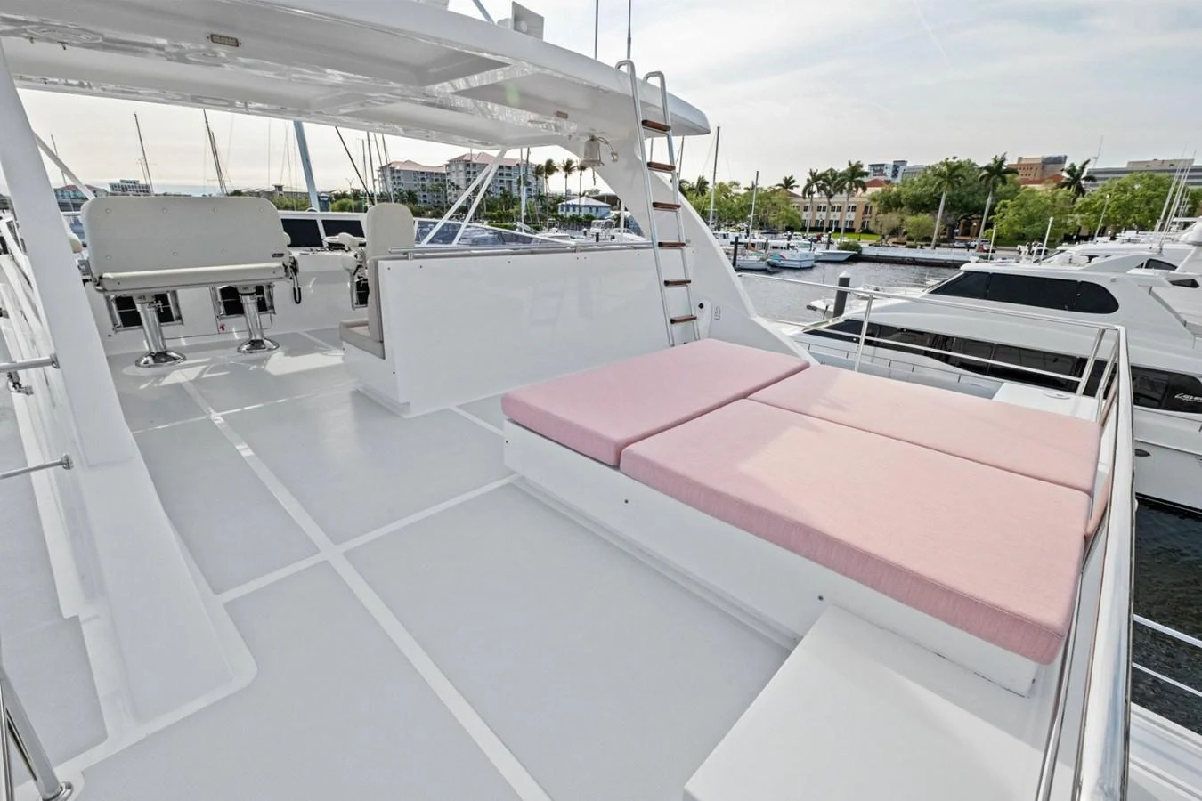The flybridge features spacious seating and sunbathing areas with a view of the marina. aboard ARTEMIS II Yacht for Sale