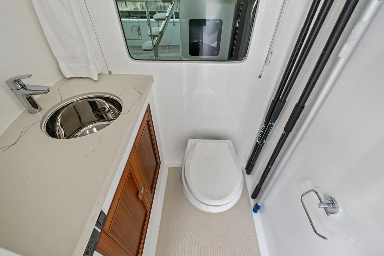 A compact and well-appointed yacht head with modern fixtures and a window providing natural light. aboard ARTEMIS II Yacht for Sale