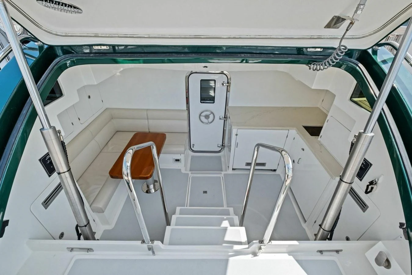 The cockpit features a spacious seating area with a wooden table and easy access to the interior. aboard ARTEMIS II Yacht for Sale