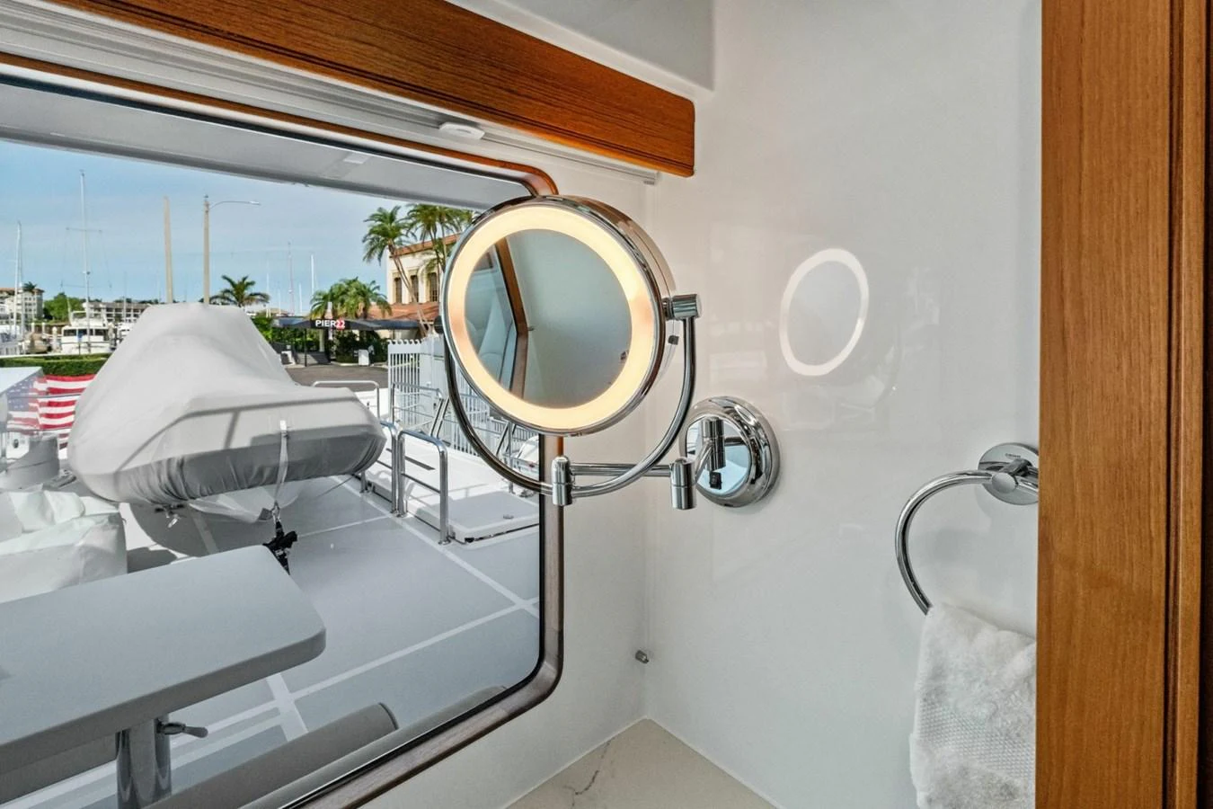 A sleek and modern bathroom with a view of the marina through a large window. aboard ARTEMIS II Yacht for Sale