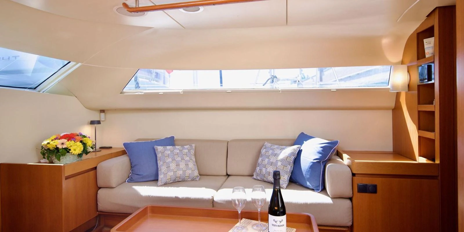 The salon features a cozy seating area with plush cushions and elegant decor. aboard LA LOEVIE Yacht for Sale