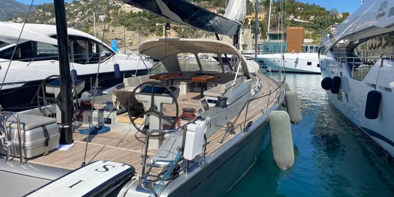 A sleek yacht is docked in a marina, showcasing its spacious deck and modern design. aboard LA LOEVIE Yacht for Sale