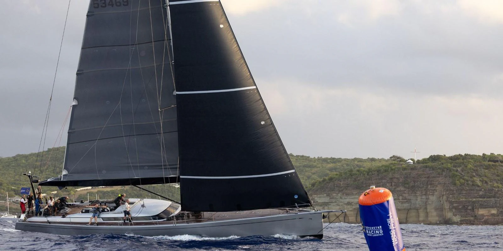 A sleek sailing yacht glides through the water with its black sails fully extended. aboard LA LOEVIE Yacht for Sale