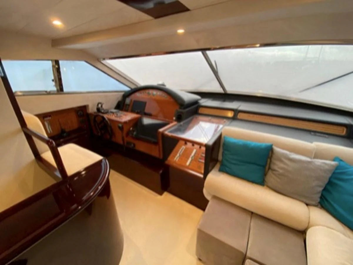 The helm area features a sophisticated control panel and a comfortable seating arrangement with plush cushions. aboard FERRETTI 810/78 Yacht for Sale