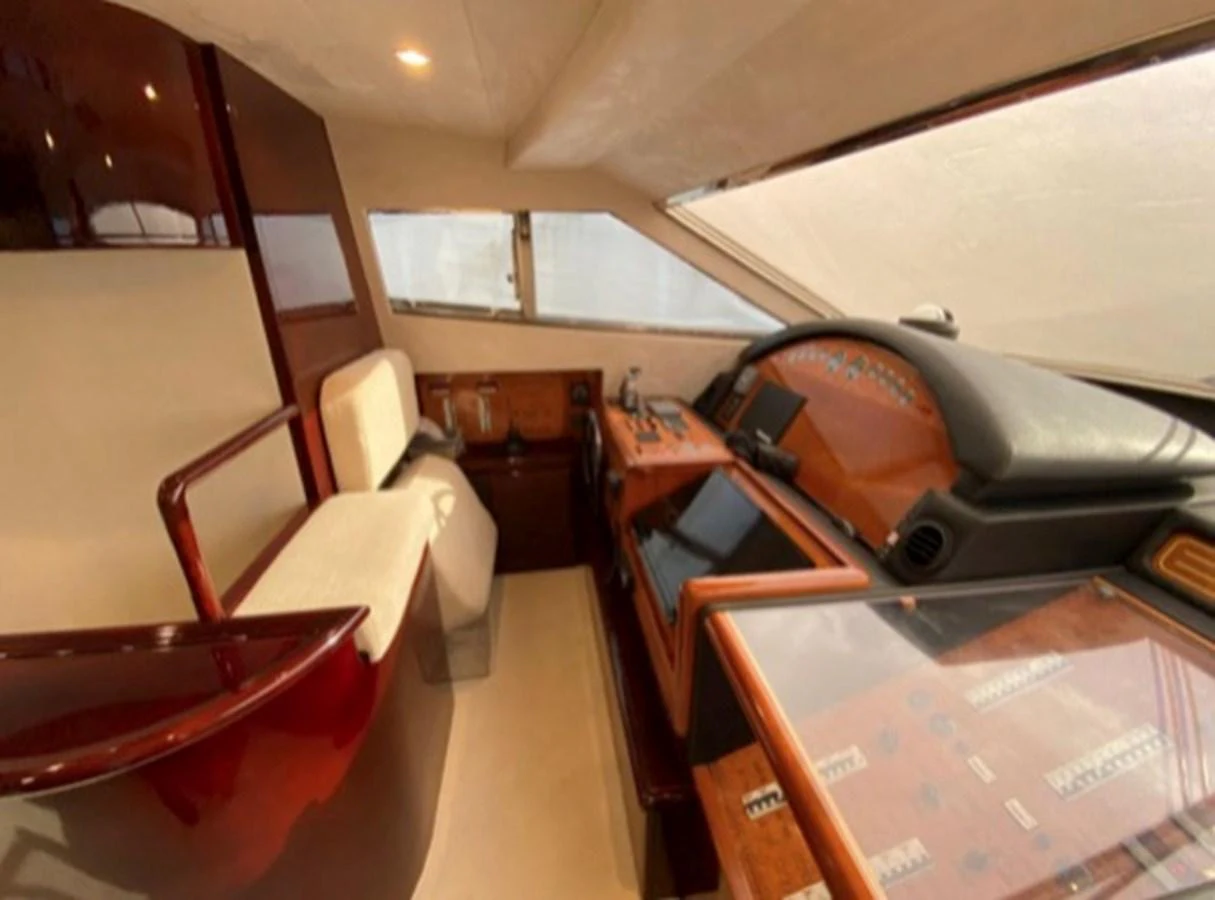 The helm station features a sleek design with modern navigation equipment and comfortable seating. aboard FERRETTI 810/78 Yacht for Sale