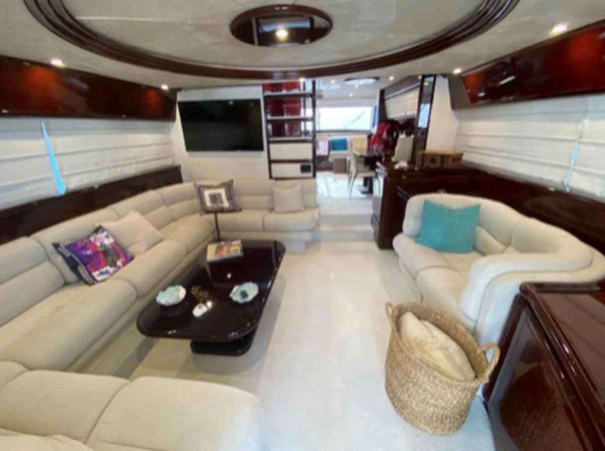 The yacht's salon features plush seating, a flat-screen TV, and elegant wood finishes, creating a luxurious and inviting atmosphere. aboard FERRETTI 810/78 Yacht for Sale