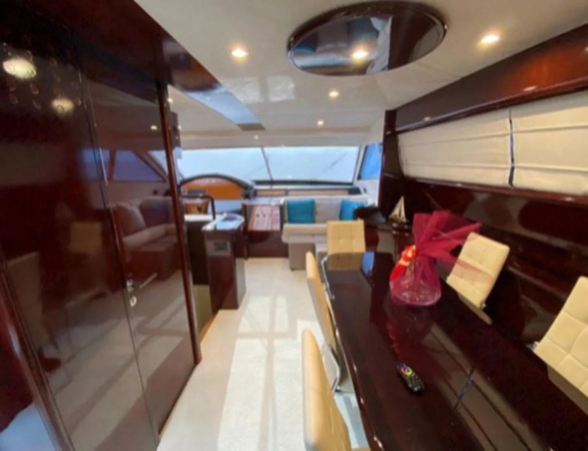 The yacht's dining area features a sleek table with comfortable seating and elegant decor. aboard FERRETTI 810/78 Yacht for Sale