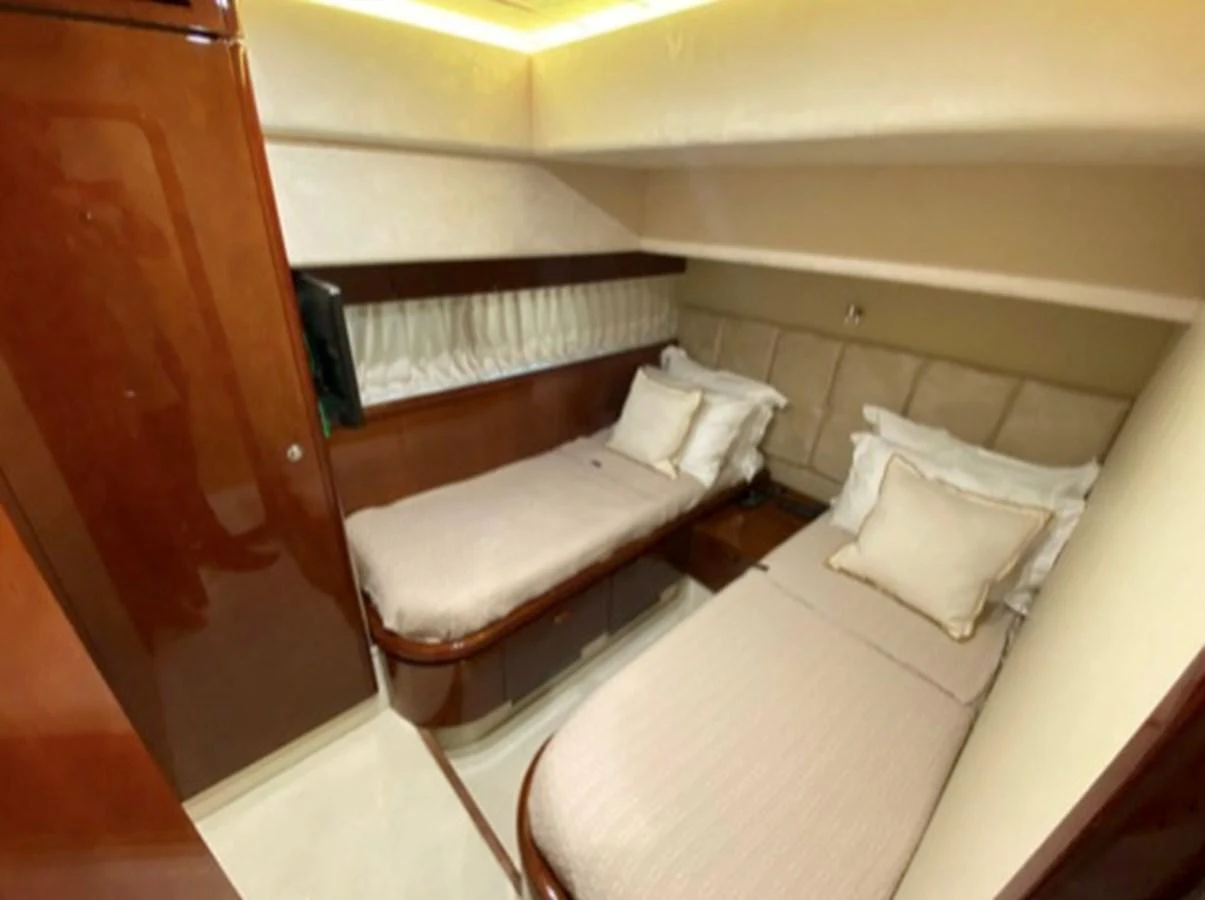 The guest stateroom features twin beds with plush bedding and elegant wood finishes. aboard FERRETTI 810/78 Yacht for Sale