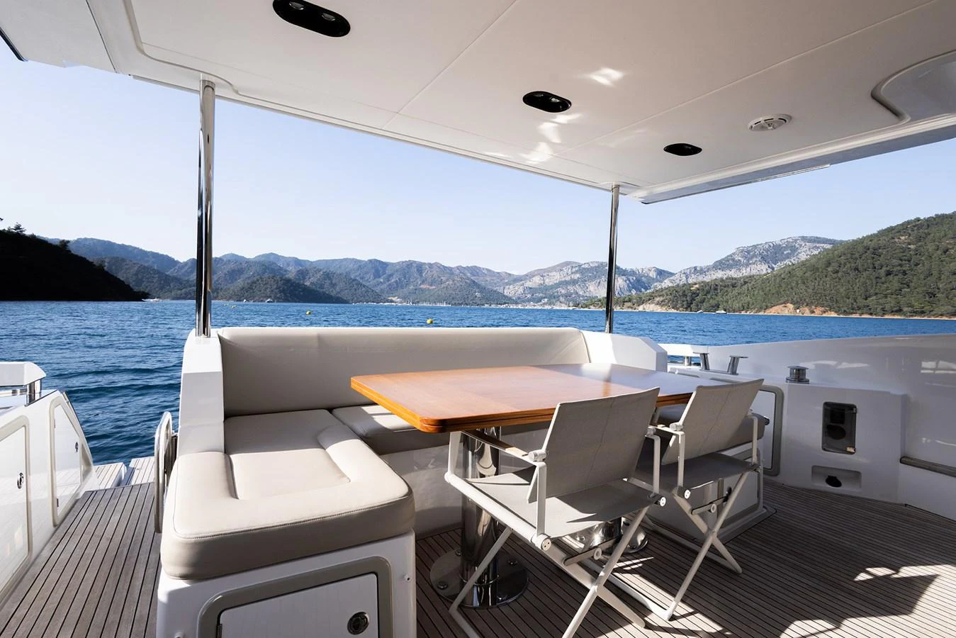 The aft deck offers a comfortable dining area with stunning views of the surrounding waters and mountains. aboard AZ FLY 66 Yacht for Sale