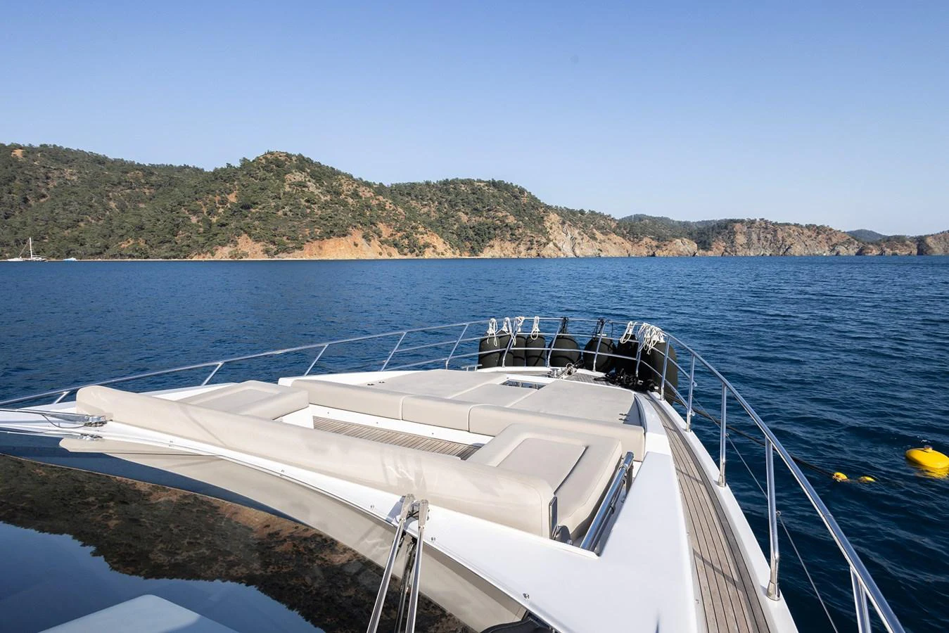 The yacht's foredeck offers a spacious sunbathing area with stunning views of the surrounding waters and coastline. aboard AZ FLY 66 Yacht for Sale