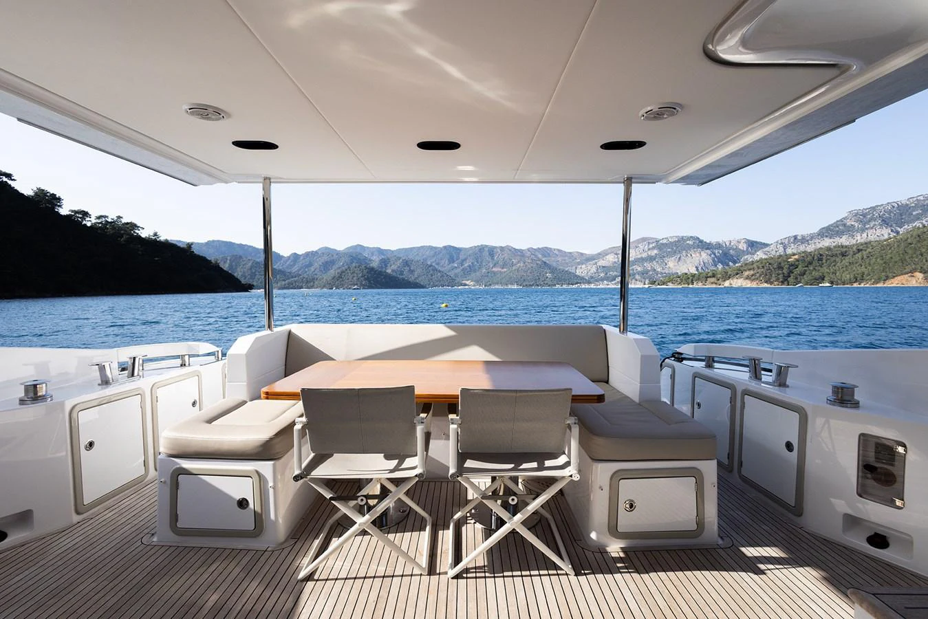 The aft deck offers a serene dining area with stunning views of the surrounding waters and mountains. aboard AZ FLY 66 Yacht for Sale