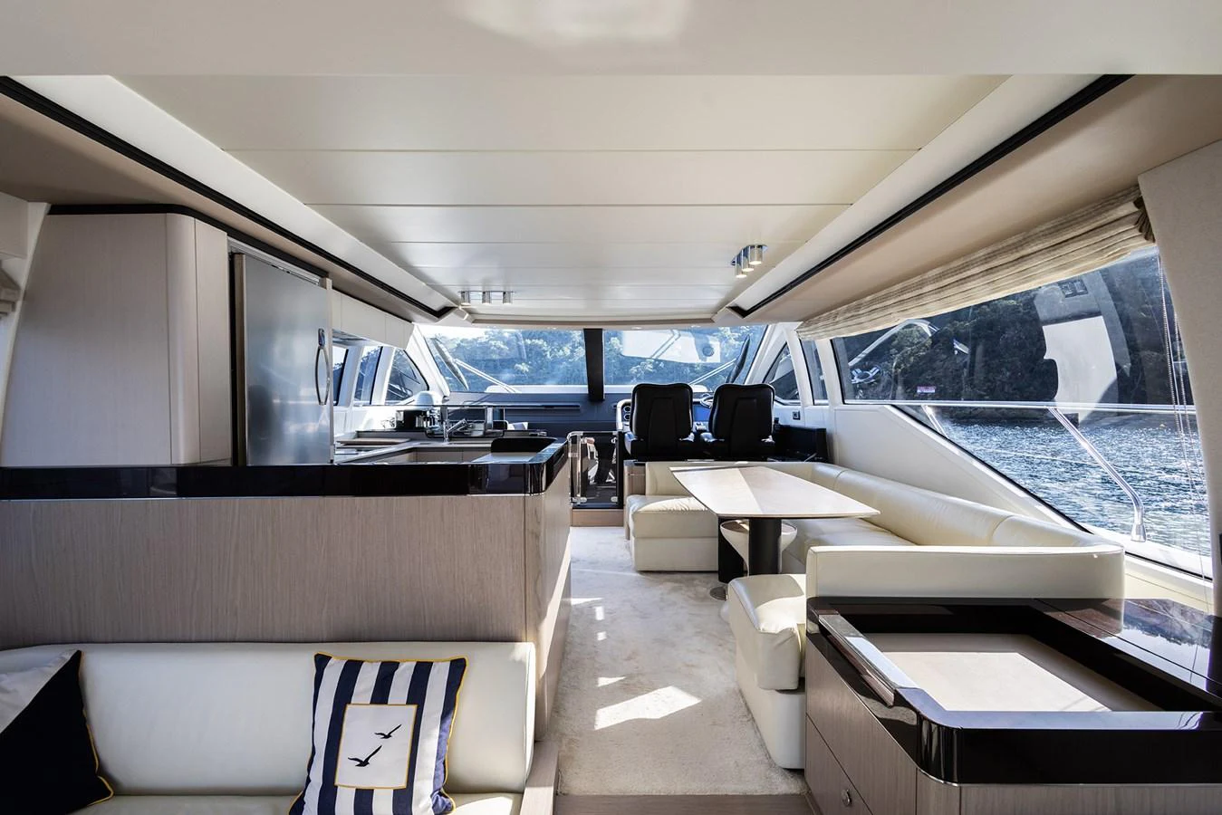 The yacht's salon features a spacious and modern design with ample seating and large windows offering stunning views. aboard AZ FLY 66 Yacht for Sale