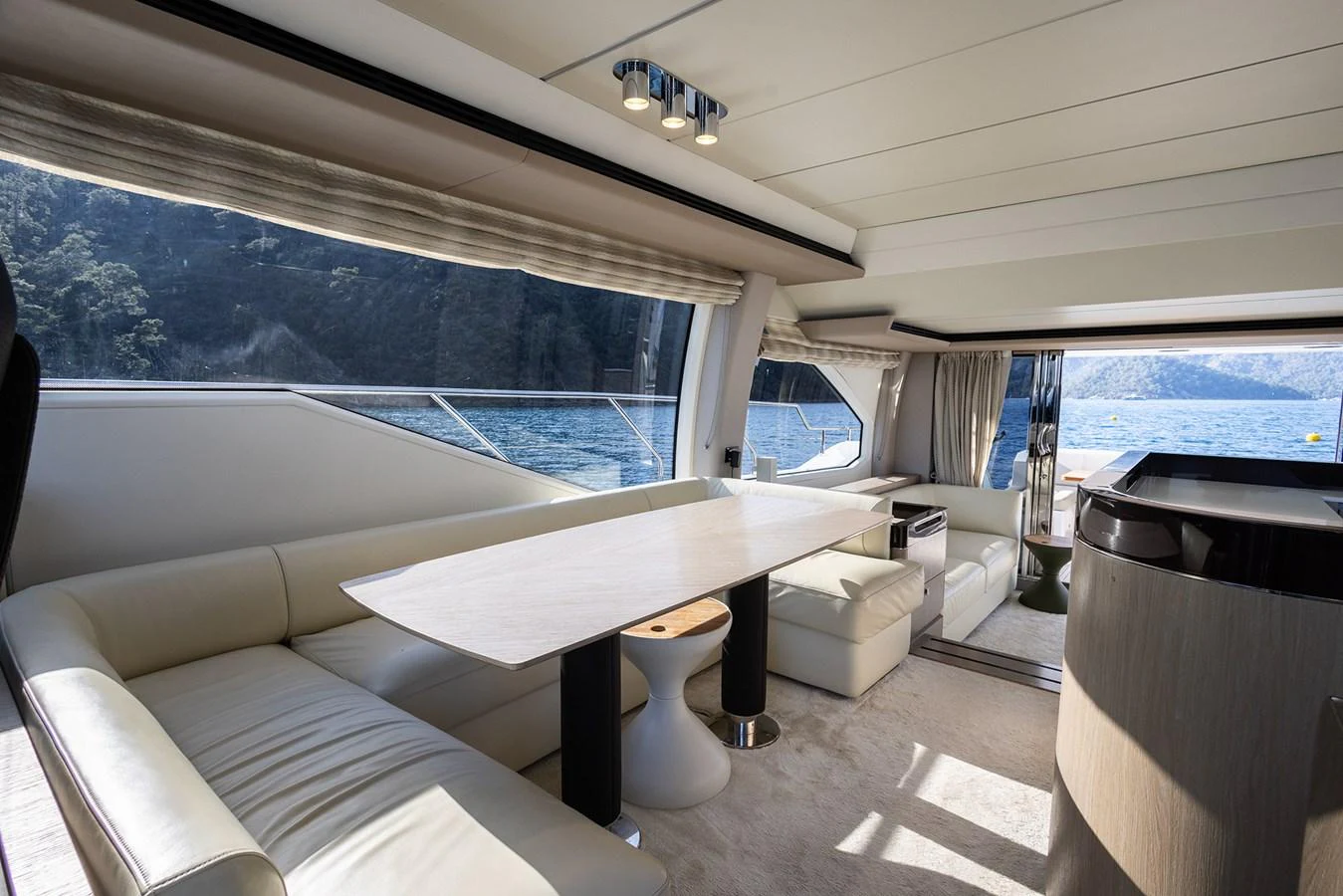 The yacht's salon features a spacious seating area with large windows offering stunning views of the water. aboard AZ FLY 66 Yacht for Sale
