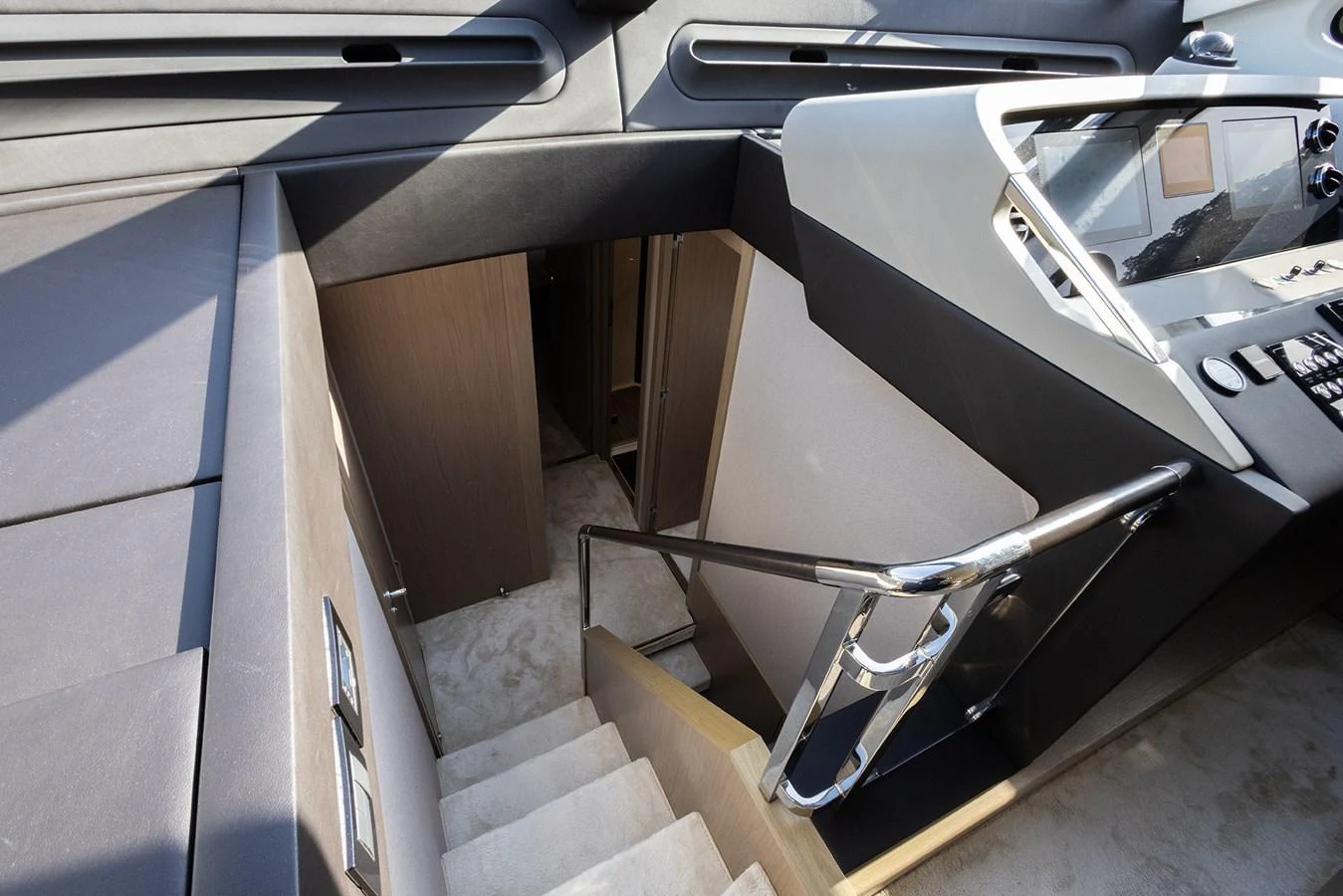 The helm station features a sleek, modern design with a staircase leading below deck. aboard AZ FLY 66 Yacht for Sale
