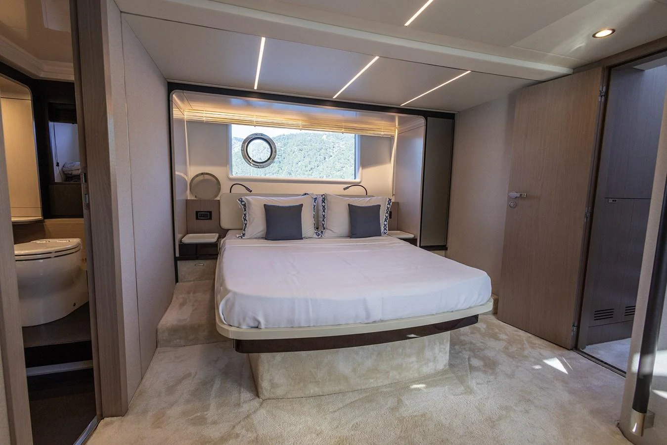 The stateroom features a luxurious bed with elegant bedding and ample natural light. aboard AZ FLY 66 Yacht for Sale