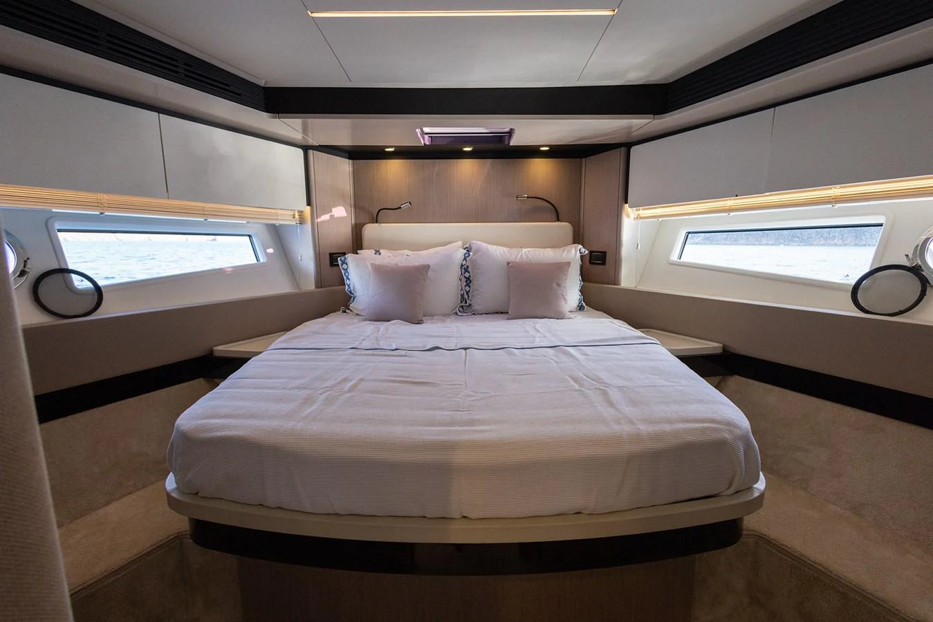 The stateroom features a plush bed with ample natural light from side windows. aboard AZ FLY 66 Yacht for Sale