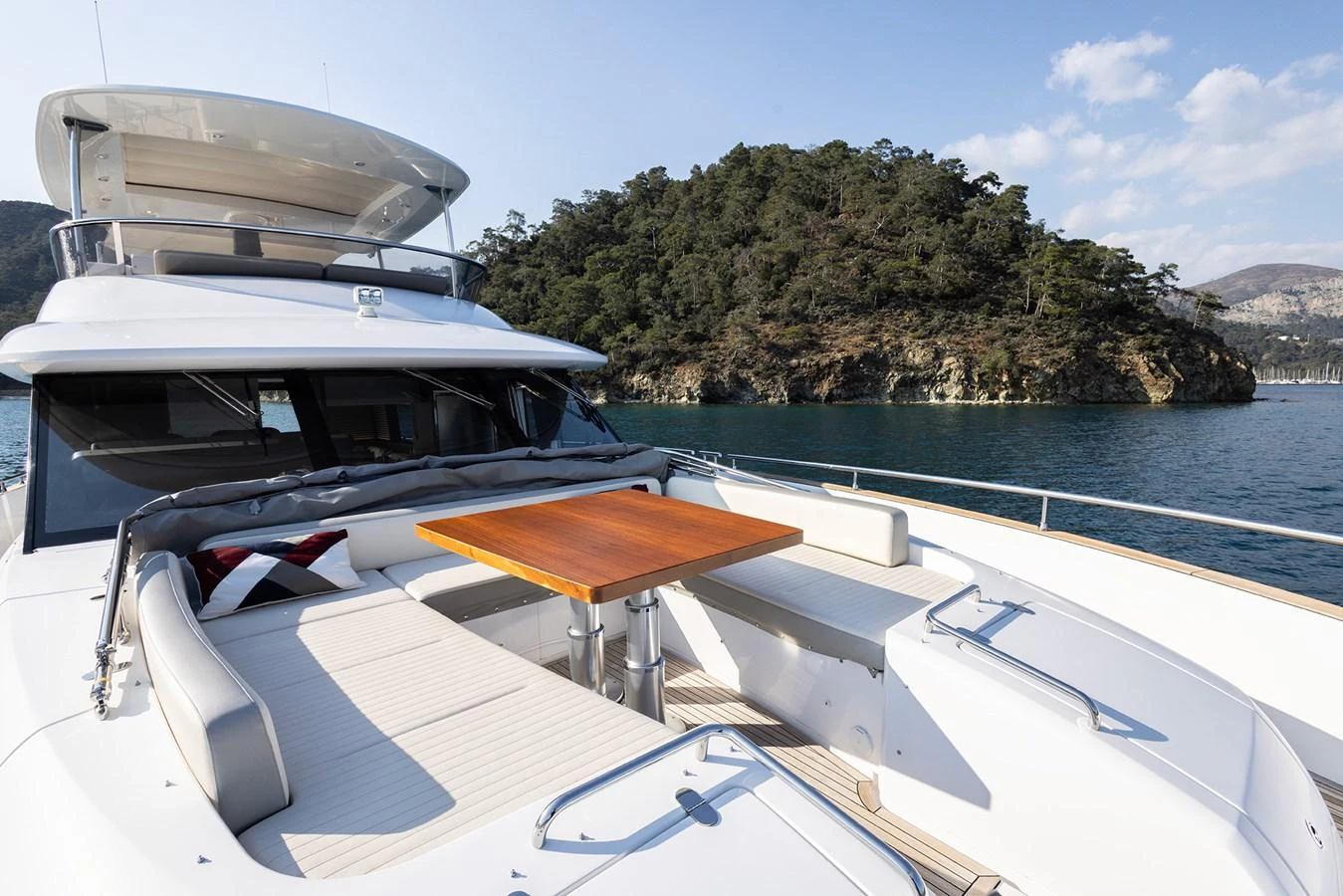 The foredeck features a spacious seating area with a wooden table, perfect for enjoying scenic views. aboard AZ MAGELLANO 66 Yacht for Sale