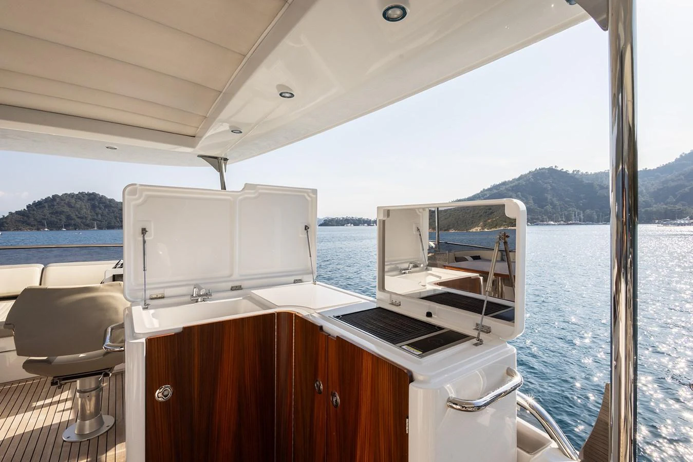 The yacht features a well-equipped outdoor galley with a scenic view of the water. aboard AZ MAGELLANO 66 Yacht for Sale