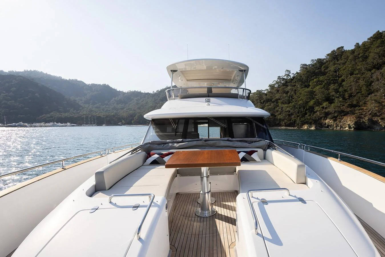 The yacht's bow area features a spacious sunbathing and lounging space with a central table, perfect for relaxation and enjoying the view. aboard AZ MAGELLANO 66 Yacht for Sale