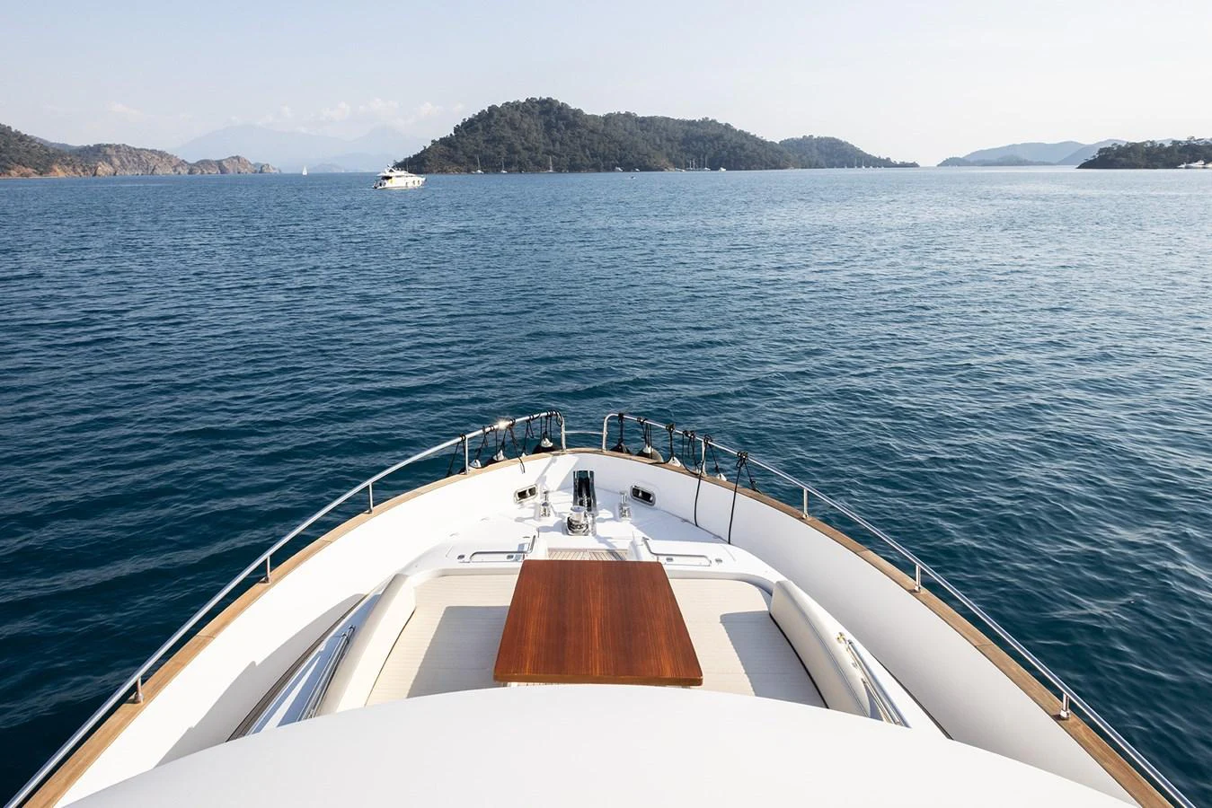The yacht's bow offers a serene view of the surrounding waters and distant islands. aboard AZ MAGELLANO 66 Yacht for Sale