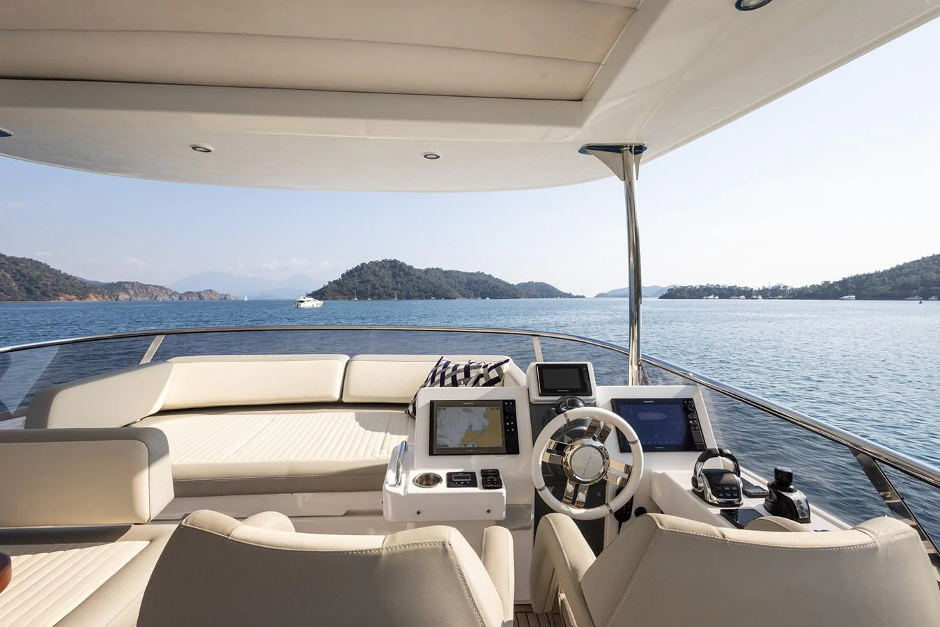 The helm station offers a panoramic view of serene waters and distant islands. aboard AZ MAGELLANO 66 Yacht for Sale