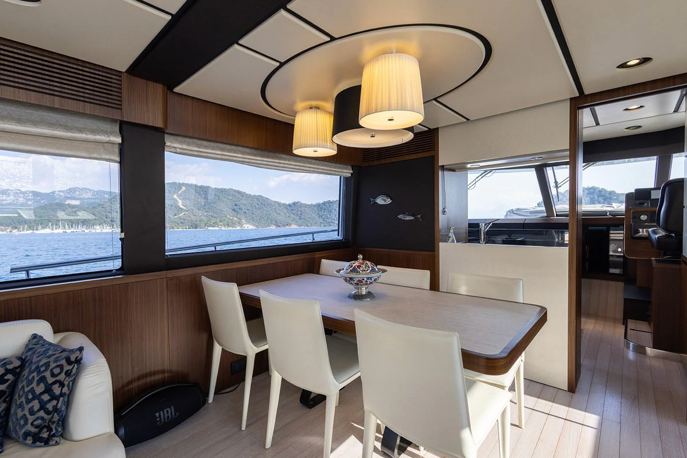 The yacht's dining area features a modern table with comfortable seating and large windows offering stunning sea views. aboard AZ MAGELLANO 66 Yacht for Sale
