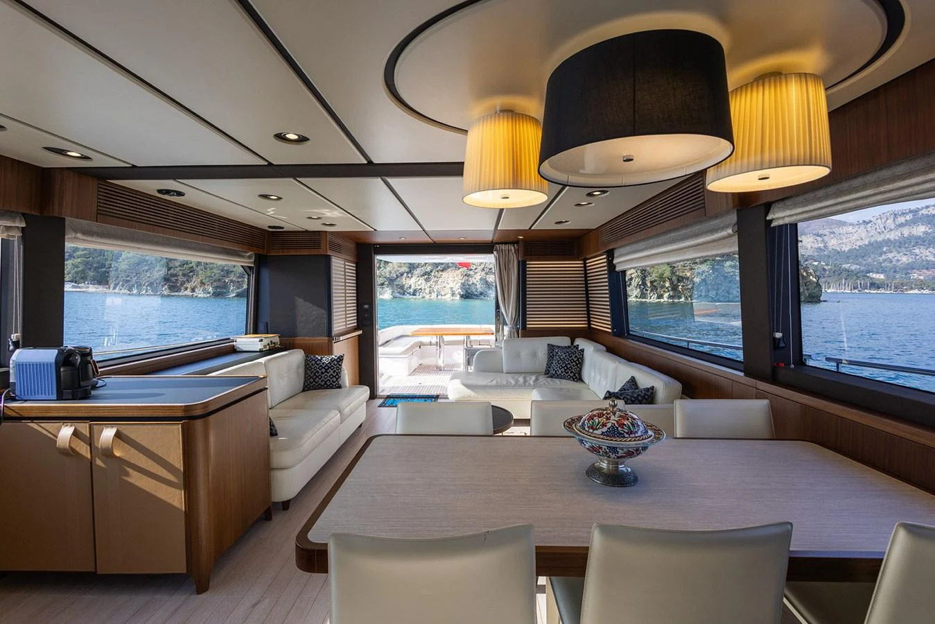The yacht's salon features elegant furnishings with ample natural light and scenic views. aboard AZ MAGELLANO 66 Yacht for Sale