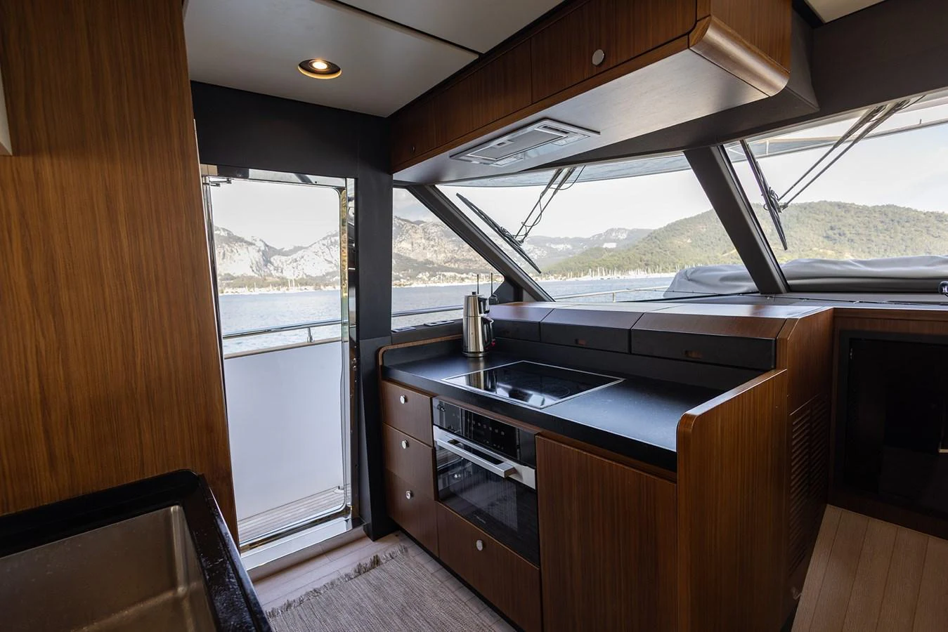 The galley offers a sleek and modern space with large windows providing stunning views. aboard AZ MAGELLANO 66 Yacht for Sale