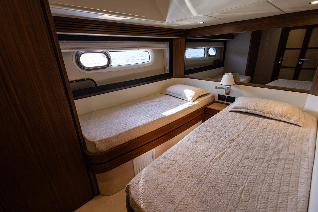The twin stateroom offers a cozy and elegant sleeping area with two single beds and a large window for natural light. aboard AZ MAGELLANO 66 Yacht for Sale
