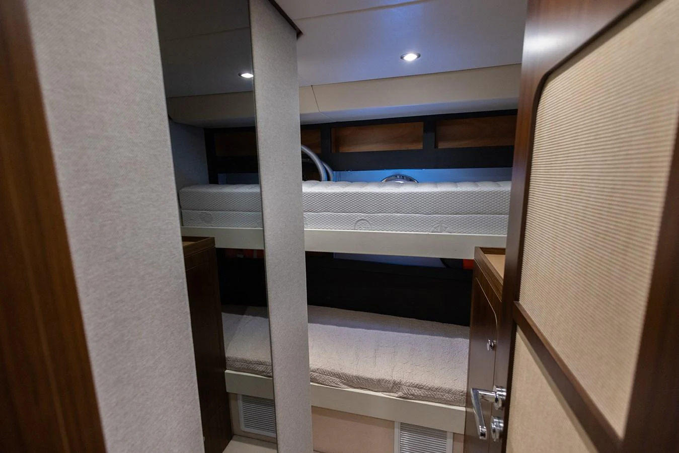 The cozy bunk cabin features comfortable bedding and warm lighting, perfect for a restful night at sea. aboard AZ MAGELLANO 66 Yacht for Sale