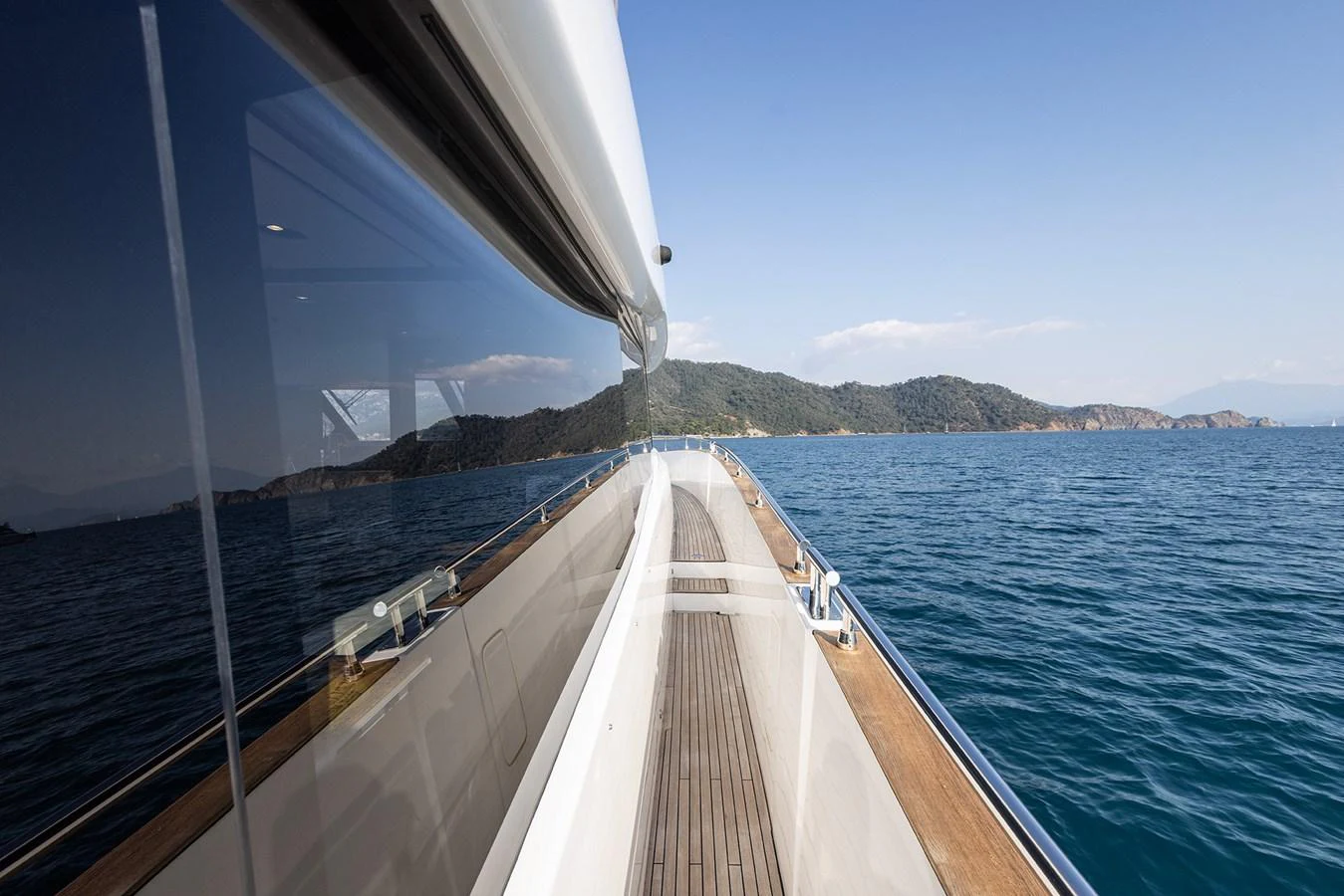 The yacht's sleek exterior deck offers a stunning view of the surrounding waters and distant coastline. aboard AZ MAGELLANO 66 Yacht for Sale