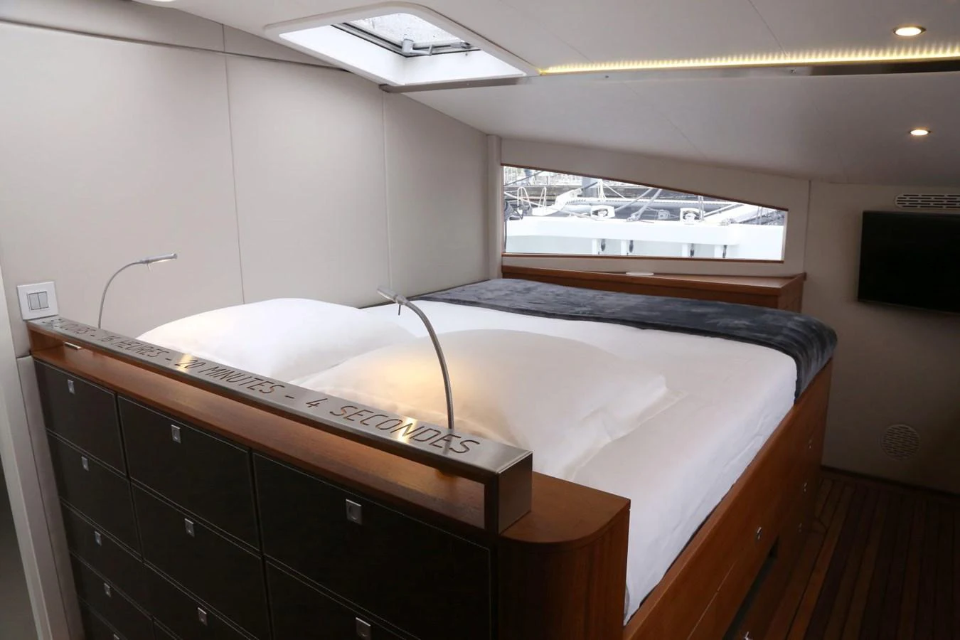 The stateroom features a comfortable bed with ample natural light from the windows and a skylight. aboard VITALIA II Yacht for Sale