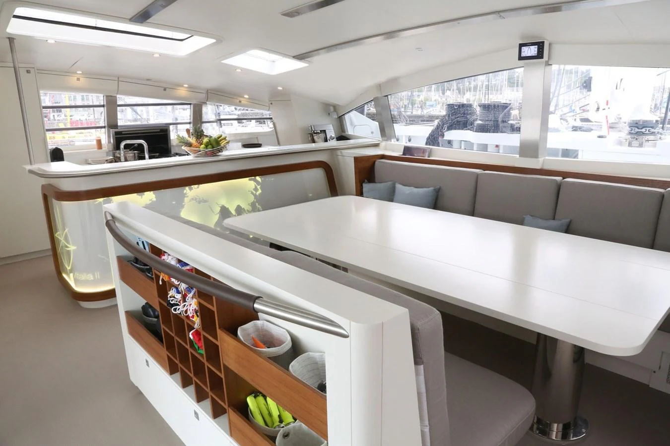 The salon features a modern dining area with ample seating and a sleek, well-equipped galley. aboard VITALIA II Yacht for Sale
