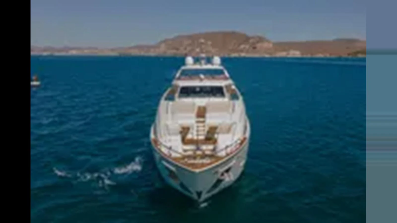 A luxurious yacht cruising on calm blue waters with a scenic coastline in the background. aboard 2012 FERRETTI YACHTS CUSTOM LINE 100 Yacht for Sale