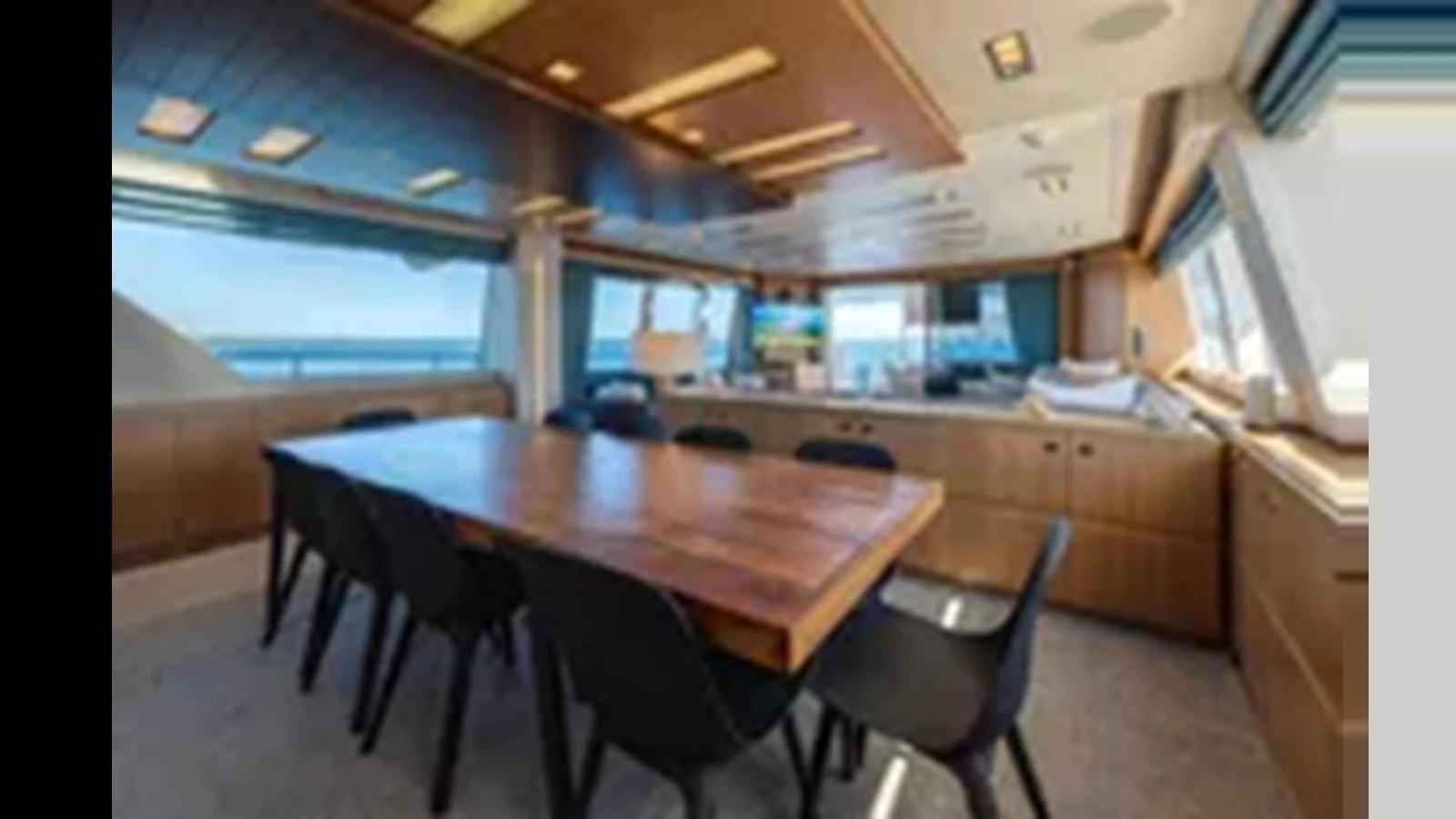 A spacious and modern dining area with a large wooden table and comfortable seating. aboard 2012 FERRETTI YACHTS CUSTOM LINE 100 Yacht for Sale