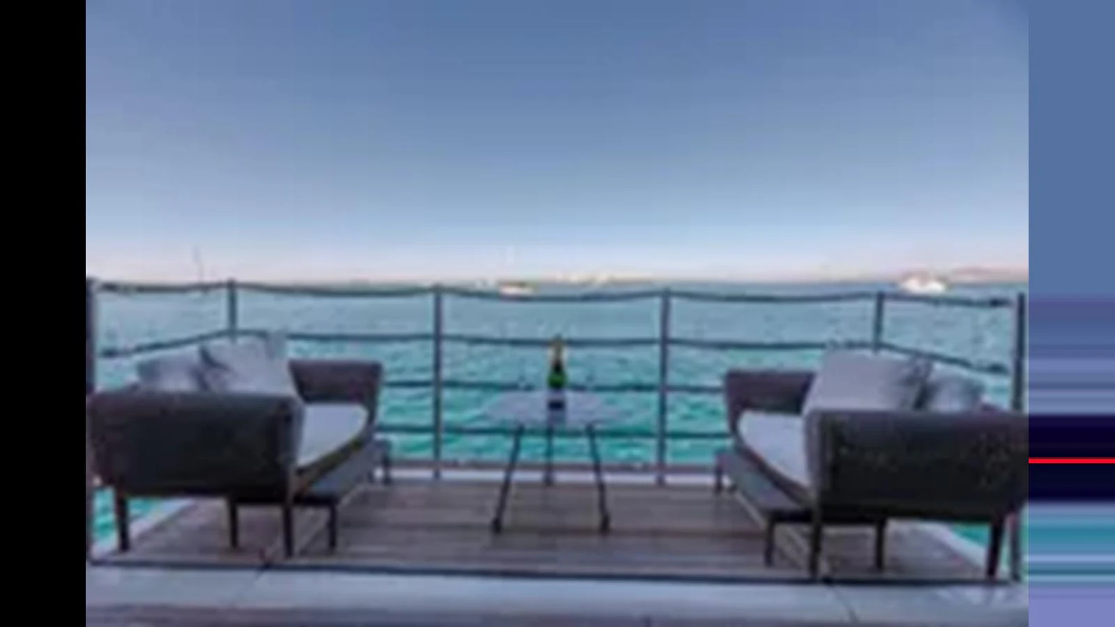 The aft deck offers a serene seating area with a stunning ocean view. aboard 2012 FERRETTI YACHTS CUSTOM LINE 100 Yacht for Sale