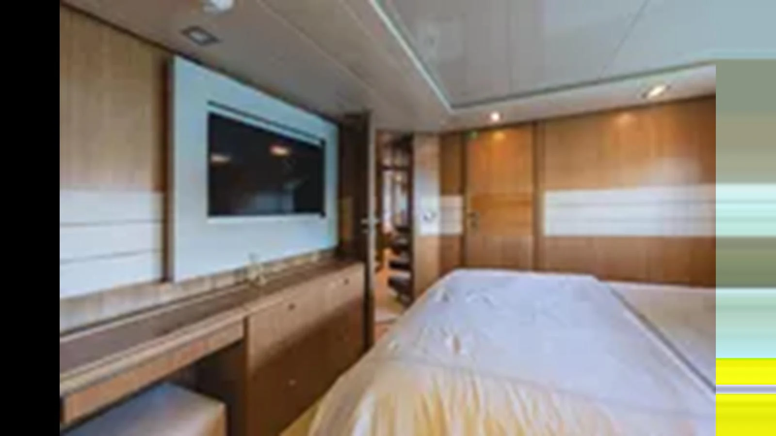 The stateroom features a large bed, a flat-screen TV, and elegant wood paneling. aboard 2012 FERRETTI YACHTS CUSTOM LINE 100 Yacht for Sale