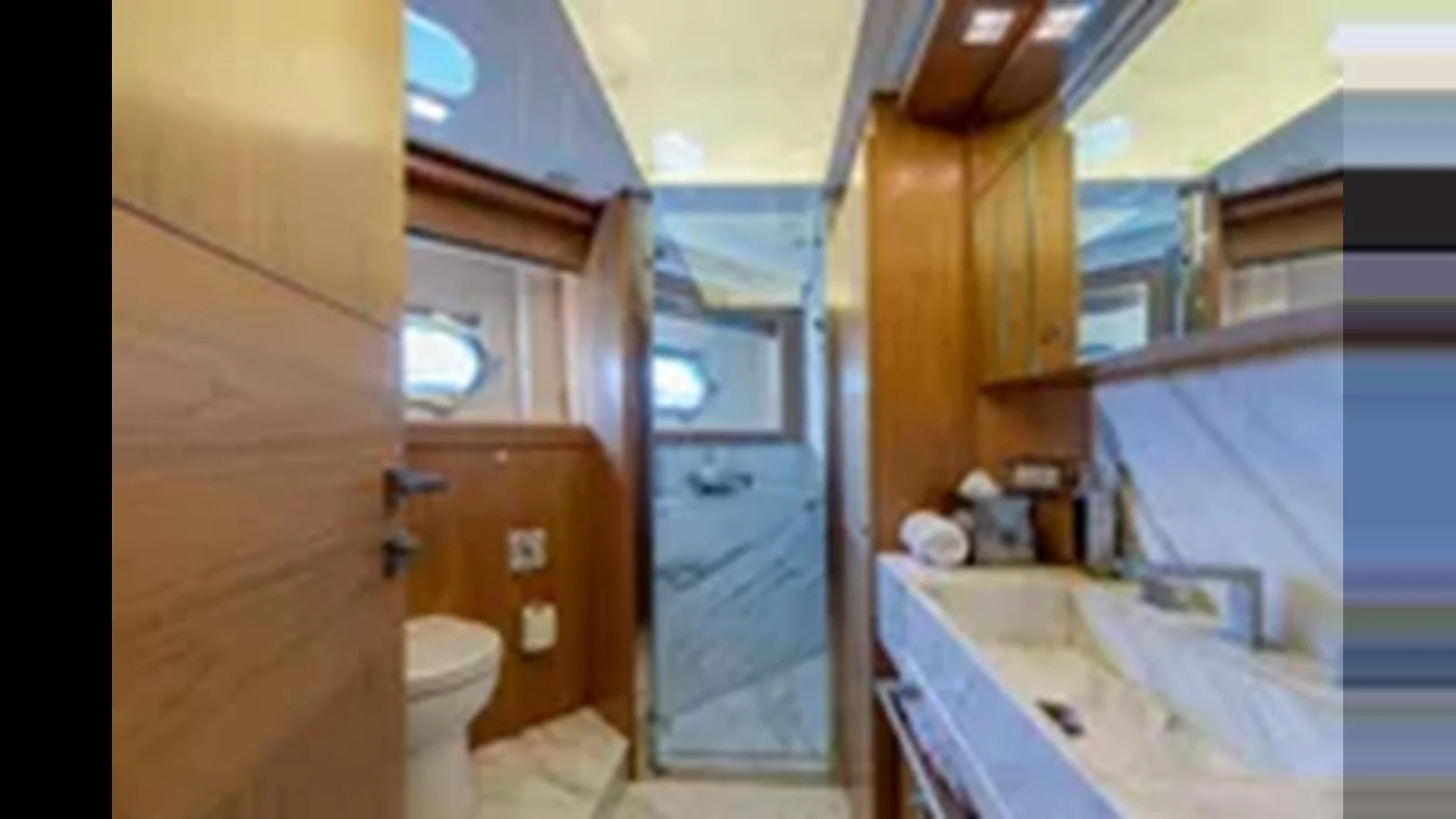 The yacht's bathroom features elegant wood finishes and a modern design. aboard 2012 FERRETTI YACHTS CUSTOM LINE 100 Yacht for Sale