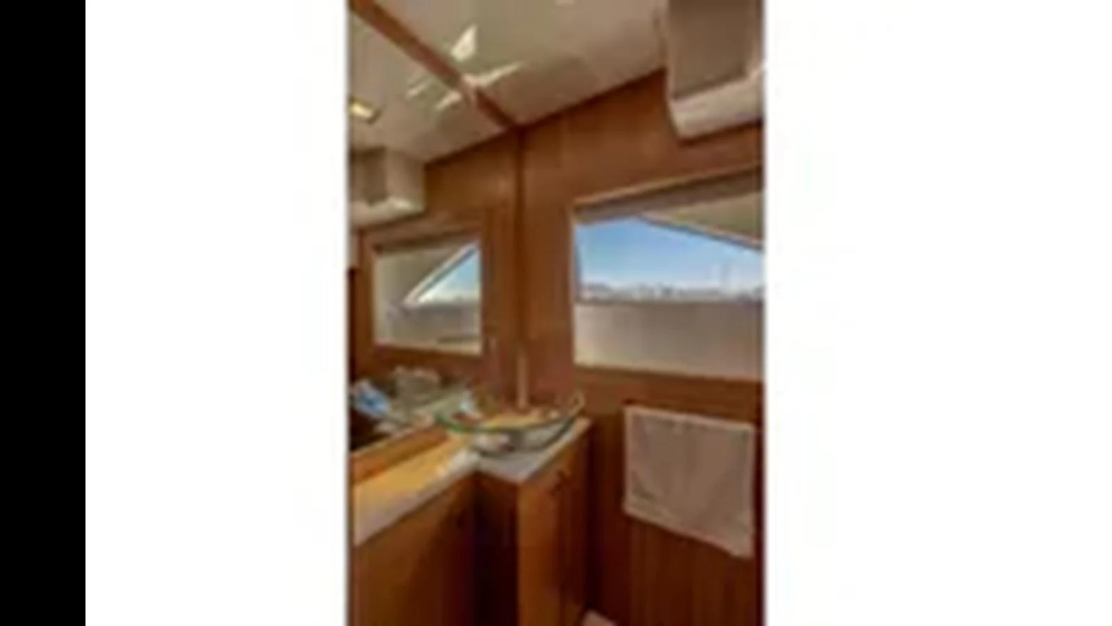 A well-appointed yacht bathroom with wooden finishes and a modern sink. aboard 2012 FERRETTI YACHTS CUSTOM LINE 100 Yacht for Sale