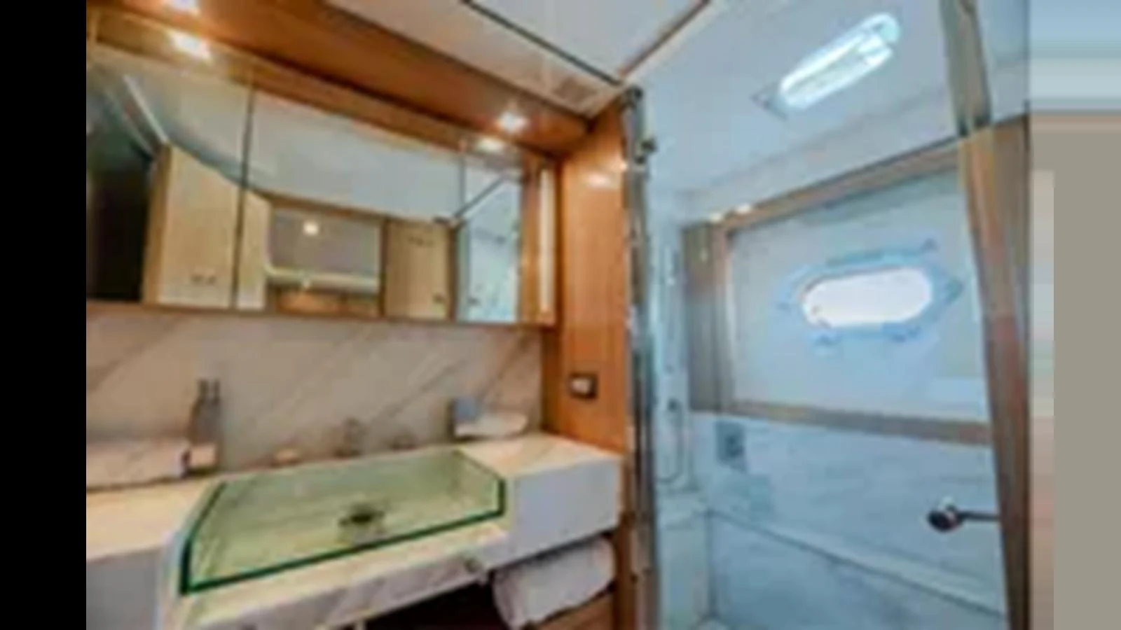 The yacht's bathroom features a modern design with a glass sink and a spacious shower area. aboard 2012 FERRETTI YACHTS CUSTOM LINE 100 Yacht for Sale