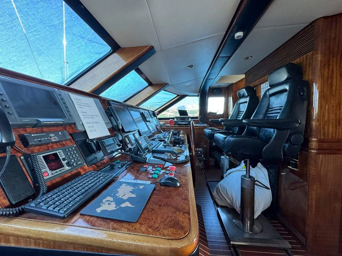 The helm station features advanced navigation equipment and luxurious seating. aboard PATRIOT Yacht for Sale