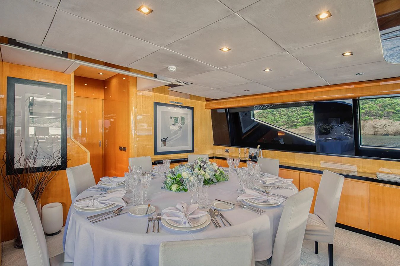 The yacht's dining area features a beautifully set table with elegant decor and ample natural light. aboard CAN'T REMEMBER Yacht for Sale