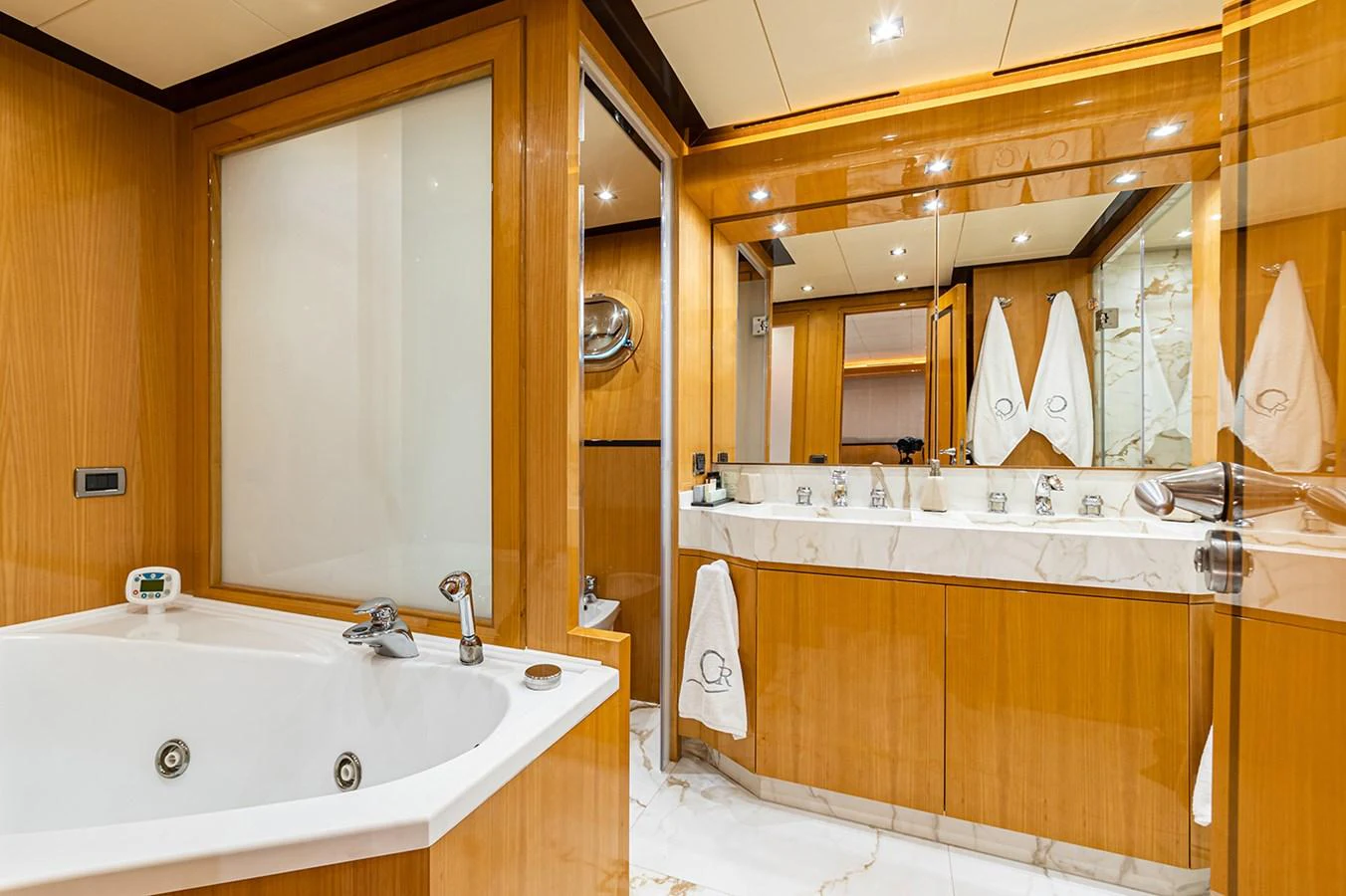 The yacht's bathroom features luxurious wood paneling and a spacious jacuzzi tub. aboard CAN'T REMEMBER Yacht for Sale