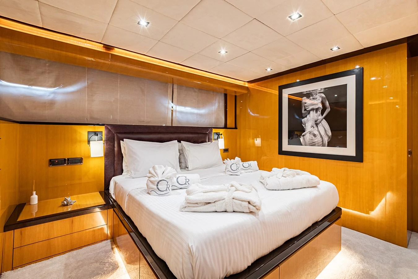 The luxurious stateroom features a plush bed with elegant linens and warm wood paneling. aboard CAN'T REMEMBER Yacht for Sale