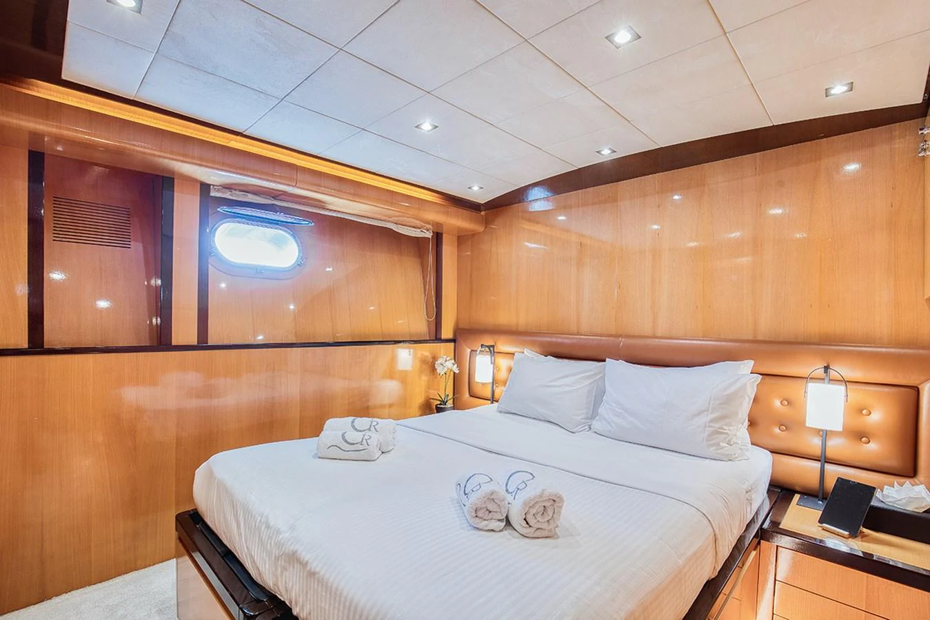 A luxurious stateroom featuring a plush bed with crisp linens and warm wood paneling. aboard CAN'T REMEMBER Yacht for Sale