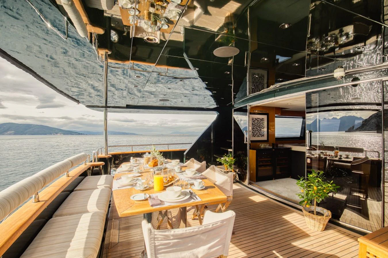 The aft deck features an elegant dining area with panoramic ocean views. aboard CAN'T REMEMBER Yacht for Sale