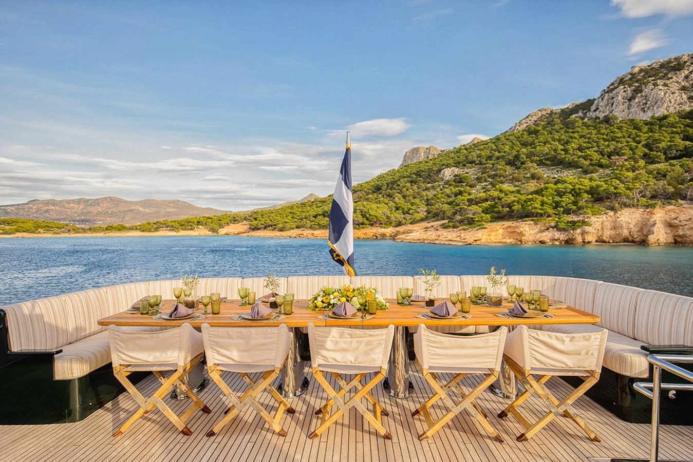 The aft deck features an elegant dining area with a stunning view of the surrounding landscape. aboard CAN'T REMEMBER Yacht for Sale